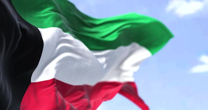 Detail of the national flag of Kuwait waving in the wind on a clear day