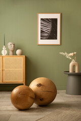 Stylish modern details of living room interior. Two massive wooden balls. Sage green wall....