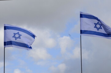 Modern building in Israel. Construction crane and workflow. Bright blue sky and white new house