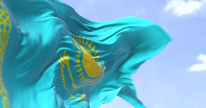 Detail of the national flag of Kazakhstan waving in the wind on a clear day.