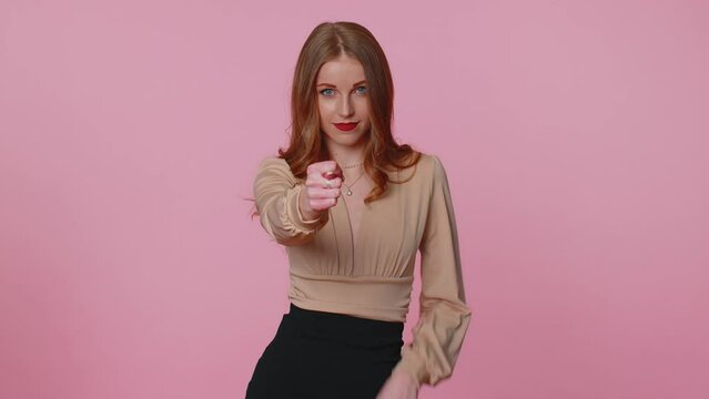 Angry aggressive greedy businesswoman girl in beige blouse showing fig gesture, you dont get it anyway. Body language. Refusal fig sign. Young adult woman isolated alone on pink studio background