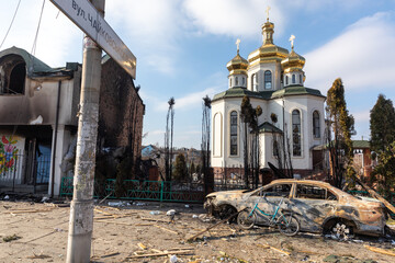 Damaged church and burned car on the outskirts of Irpin