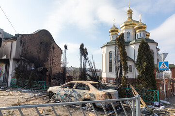 Damaged church and burned car on the outskirts of Irpin