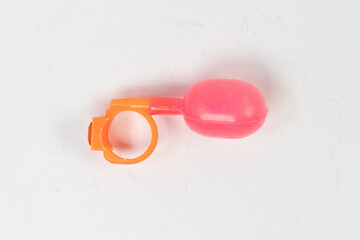 Joke ring toy isolated on white background, water squirting fake ring for kids, old toys