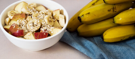 Bowl of chopped banana and apple with rolled oats