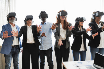 Business people wearing vr goggles inside office - New technology and metaverse concept - Main focus on indian man face