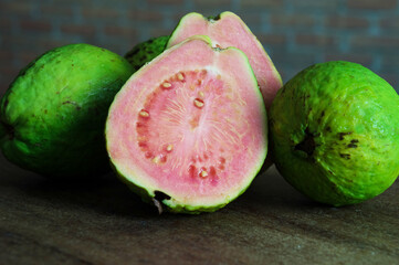 Red guava halved among whole guavas
