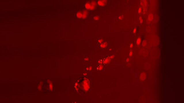 Abstract red bubbles moving in a red liquid perfect for chemistry shot.
