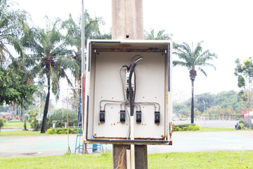 Old Breaker small broken electrical is damaged in park. Temporary distribution electric control outdoor for business. Main substation power button to distribute electricity supply.