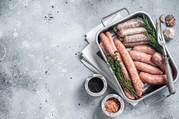 Assorted raw sausages. Beef, pork, lamb and chicken mince meat sausages in a steel kitchen tray...
