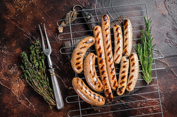 Assortment of different bbq grilled sausages with Beef, pork, lamb and chicken meat on a grill....