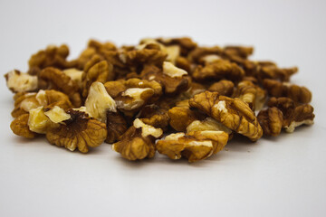Peeled walnuts on white background