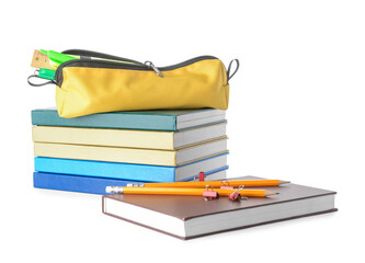 Stack of books and pencil case with stationery on white background