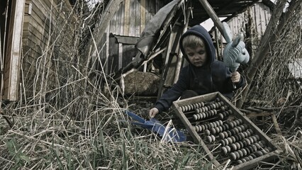 Child playing war in ruins 