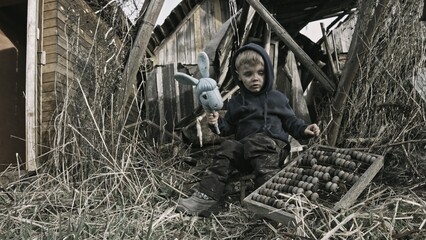 Child playing war in ruins 