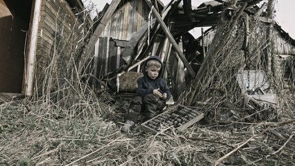 Child playing war in ruins 