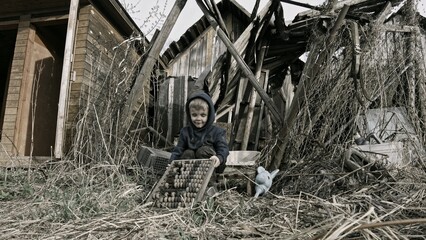 Child playing war in ruins 