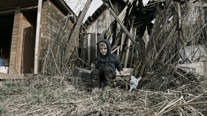 Child playing war in ruins 