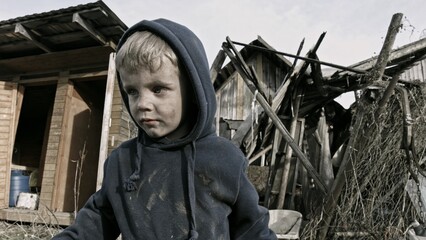Child playing war in ruins 