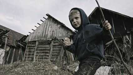 Child playing war in ruins 