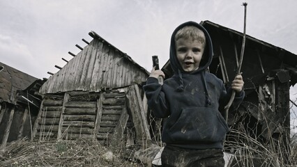 Child playing war in ruins 