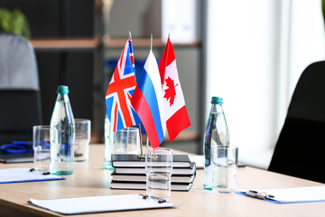British, Canadian and Russian flags on table in office