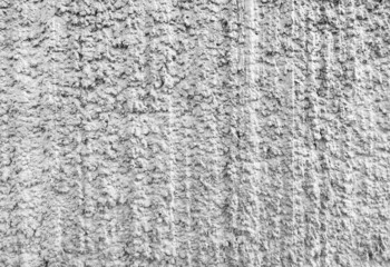 Gray volumetric background of drop-shaped cement with vertical, barely noticeable stripes