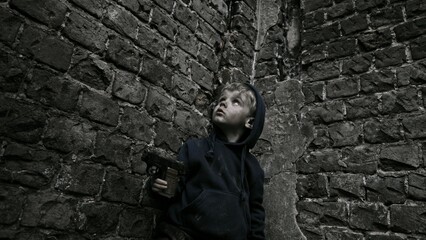 Fototapeta na wymiar Child playing war in ruins