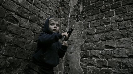 Fototapeta na wymiar Child playing war in ruins