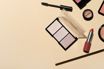 Different cosmetic products on beige background