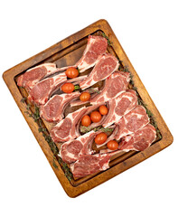 Lamb chops isolated on a white background. Raw lamb chops on wood serving board. Top view
