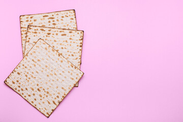 Jewish flatbread matzo for Passover on pink background