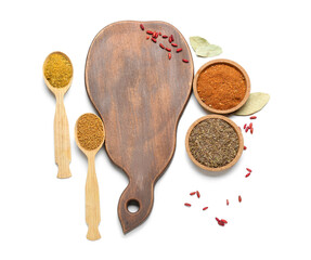 Wooden board and aromatic spices on white background