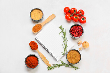 Composition with blank notebook, vegetables and spices on light background