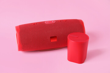 Wireless portable speakers on pink background