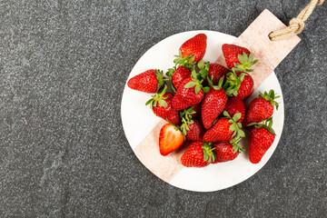 strawberries on black background on marble