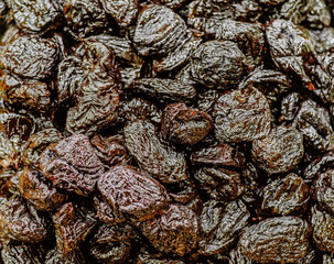 Shiny black prunes. Sale of prunes. Dietary food. The concept of healthy eating.