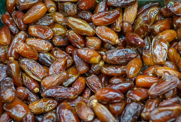 Dried shiny dates. Sale of dried fruits. Dietary food. The concept of healthy eating. Abstract background.