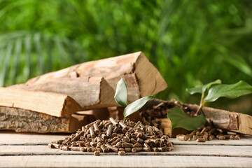 Pile of wood pellets on light wooden table outdoors