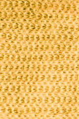 Texture of natural warm knitted fabric pattern yellow color.