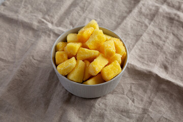 Organic Frozen Pineapple Slices in a Bowl, low angle view.