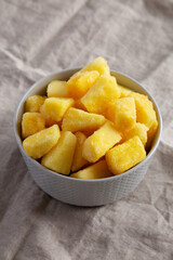 Organic Frozen Pineapple Slices in a Bowl, side view.