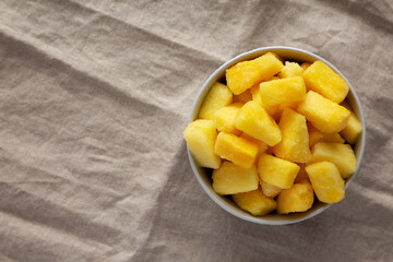 Organic Frozen Pineapple Slices in a Bowl, top view. Flat lay, overhead, from above. Copy space.