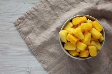 Organic Frozen Pineapple Slices in a Bowl, top view. Flat lay, overhead, from above. Space for text.