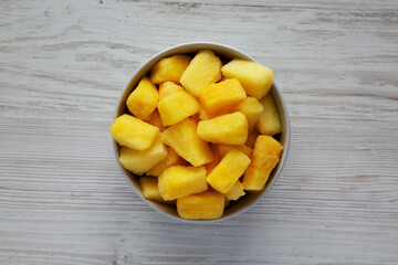 Organic Frozen Pineapple Slices in a Bowl, top view. Flat lay, overhead, from above.