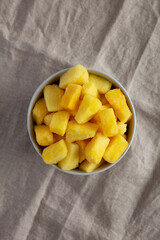 Organic Frozen Pineapple Slices in a Bowl, top view. Flat lay, overhead, from above.