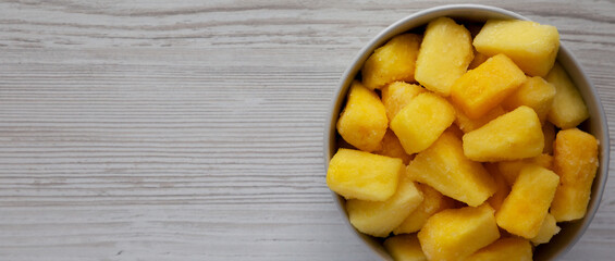 Organic Frozen Pineapple Slices in a Bowl, top view. Flat lay, overhead, from above. Copy space.