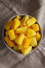 Organic Frozen Pineapple Slices in a Bowl, top view. Flat lay, overhead, from above.