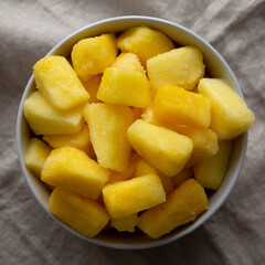Organic Frozen Pineapple Slices in a Bowl, top view. Flat lay, overhead, from above.