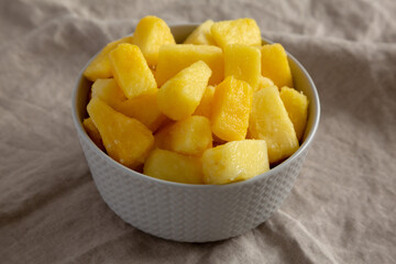 Organic Frozen Pineapple Slices in a Bowl, side view. Close-up.